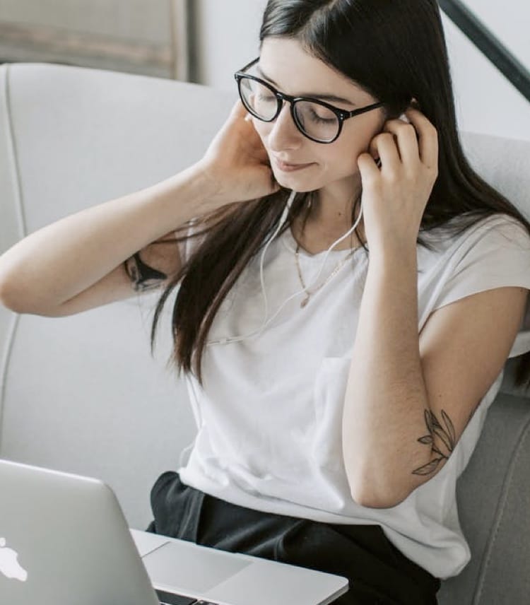 background image of lady behind laptop listening music